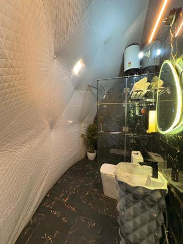 a bathroom with a sink and a toilet in a room at Manzil Escapes in Mussoorie