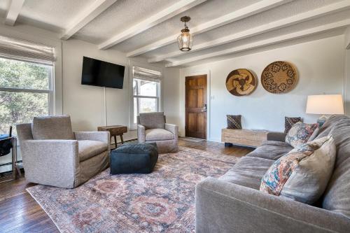 a living room with a couch and chairs and a tv at Tesuque Outpost Casita E Best views in Santa Fe in Santa Fe