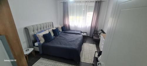a small bedroom with a bed and a window at Villa Buki in Lezhë