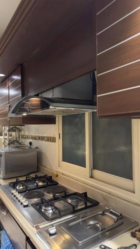 a kitchen with a stove top in a kitchen at مسكن كازان in Abha