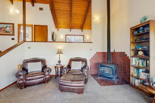 a living room with two chairs and a fireplace at Seaside Serenity Near the Sea in Seaside