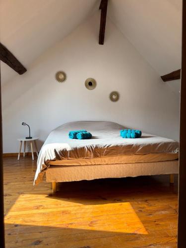 ein Schlafzimmer mit einem Bett mit blauen Kissen darauf in der Unterkunft Appartement cosy en plein coeur de Montargis in Montargis