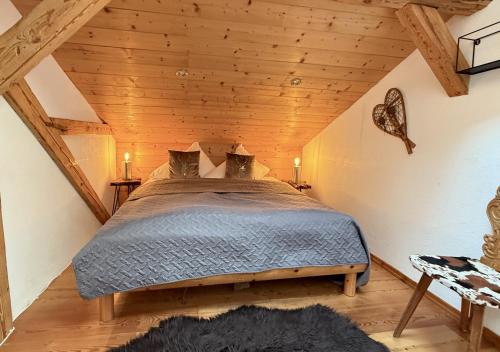 a bedroom with a bed in a attic at CHALET BELLE WILD by Belle Stay in Going