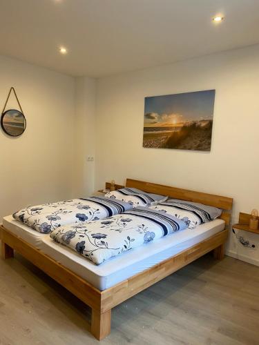 a bed in a bedroom with a picture on the wall at Ferienwohnung direkt am Goldberg in Selb in Selb