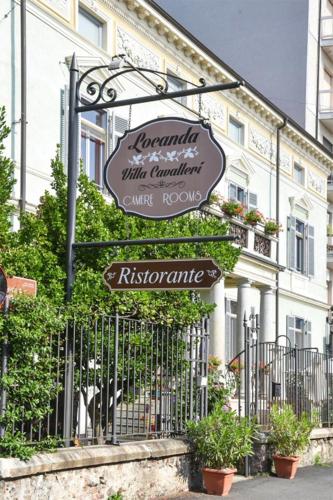 a sign in front of a building with a fence at Villa Cavalleri in Gattinara