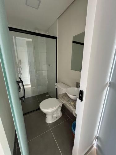 a bathroom with a toilet and a sink at Hotel Santa Catarina in Santos