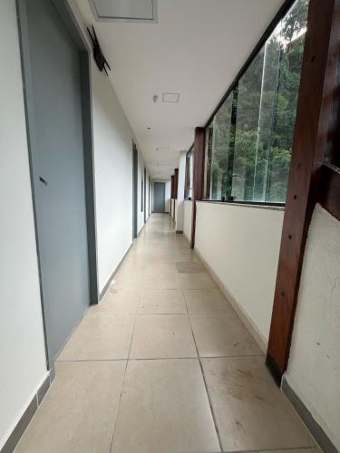 an empty hallway in an office building with windows at Hotel Santa Catarina in Santos