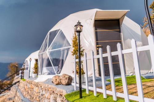 a large dome tent with a white fence at Manzil Escapes in Mussoorie