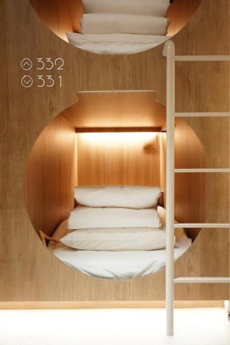 a circular room with a bunk bed in it at D A L Premium Capsule Hotel in Seoul