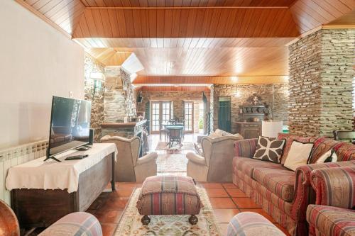 a living room with a couch and a tv at Casa dos Araújos in Mirandela