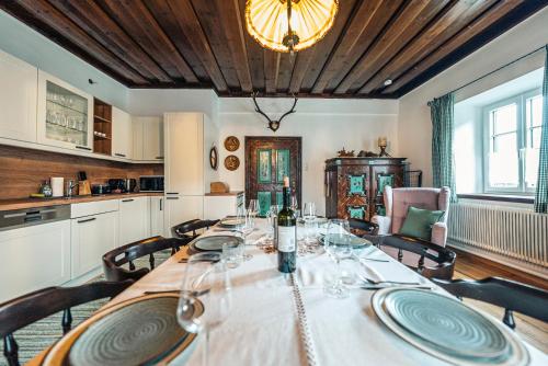 a dining room with a table with wine glasses on it at SIEGLGUT in Altaussee