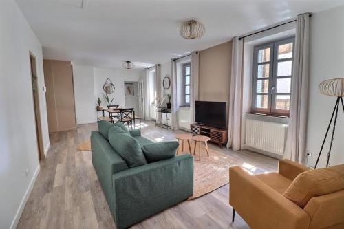 un salon avec deux canapés et une télévision dans l'établissement Chez Nel, à Figeac