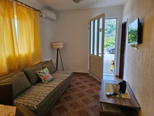a living room with a couch and a table at Vila Marina in Buljarica