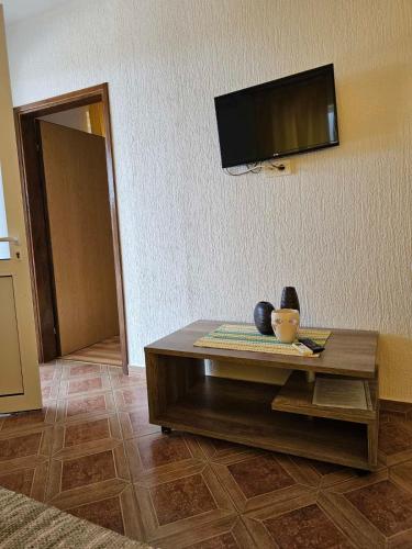 a living room with a coffee table and a flat screen tv at Vila Marina in Buljarica