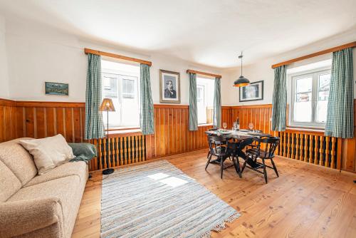 a living room with a couch and a table at SIEGLGUT in Altaussee