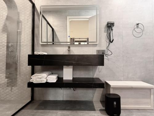 a bathroom with a sink and a mirror at Oasis Breez - Family Room in Kudafari