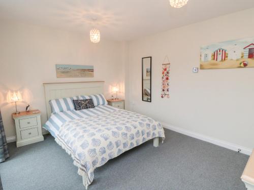 a bedroom with a bed and two night stands at Sunny Bay in Reighton