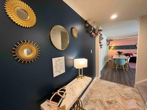 a room with three mirrors on a blue wall at Pretty Posh Pad-Block to Ocean Casino & Waterpark in Atlantic City