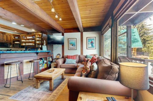 a living room with a couch and a table at Hyak Duplex Cabin in Snoqualmie Pass
