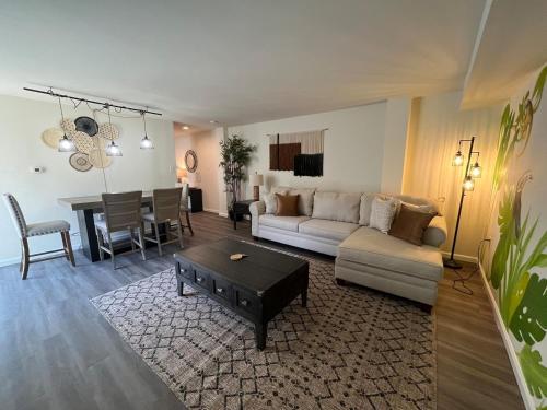 a living room with a couch and a table at Palm Court-Trendy & Block from Ocean Casino in Atlantic City