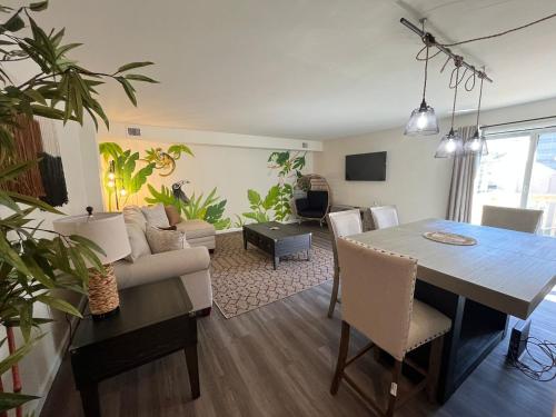 a dining room and living room with a table and chairs at Palm Court-Trendy & Block from Ocean Casino in Atlantic City