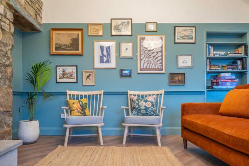 a living room with two chairs and a couch at Otter Hostel Connemara in Leenaun