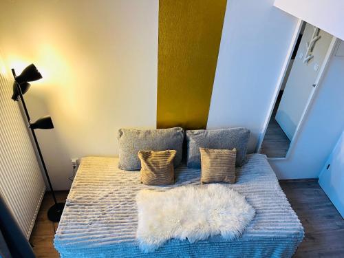 a bed with two pillows and a blanket at Feldhouse in Bremen