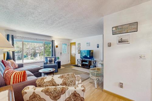a living room with a couch and a chair at Cottage on Hemlock Street in Cannon Beach