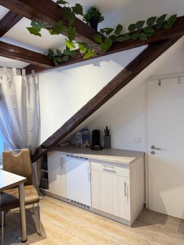 a kitchen with a counter and a table at Lucky Home Relax Appartment in Füssen
