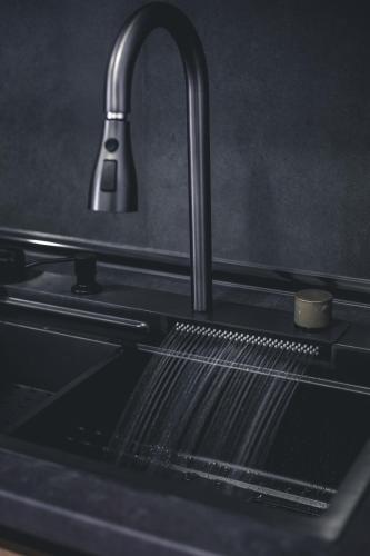 a kitchen sink with a faucet and a sink at Apartman Eden Bihać in Bihać