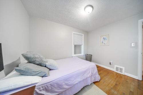 a bedroom with a bed with two pillows on it at Walk to Lake Erie and Beach Access Home with Deck! in Erie