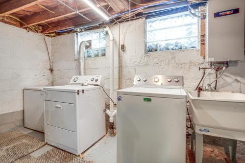 a kitchen with a washing machine and a sink at Walk to Lake Erie and Beach Access Home with Deck! in Erie