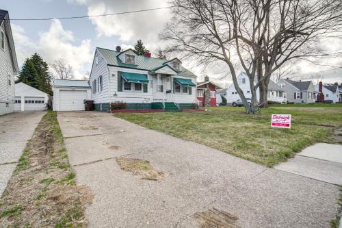 a house with a for sale sign in a yard at Walk to Lake Erie and Beach Access Home with Deck! in Erie