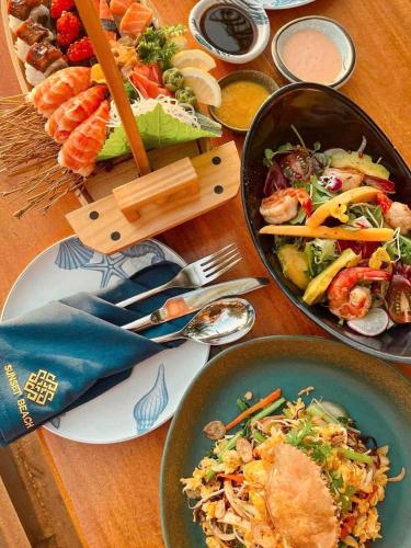 a wooden table with two bowls of food on it at Sunset Beach Resort and Spa in Phu Quoc