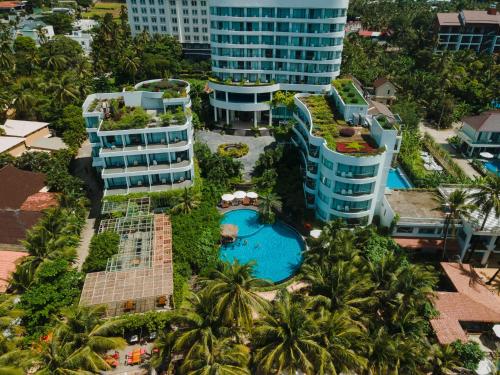 an aerial view of a resort with a pool and palm trees at Sunset Beach Resort and Spa in Phu Quoc