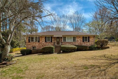 a home with a brick house with a yard at Spacious 4BR Retreat in Vibrant Smyrna Near Lakes in Smyrna