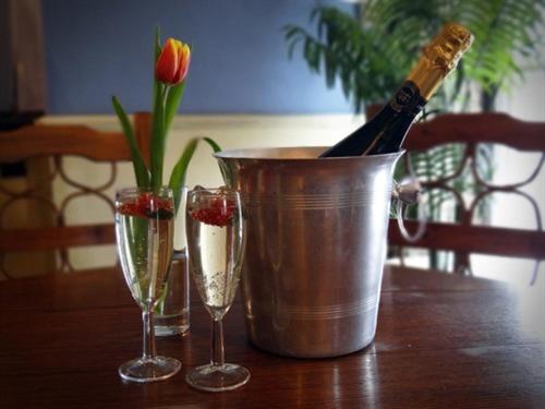 a bucket of champagne and two glasses on a table at Anchor Hotel Haydon Bridge in Hexham