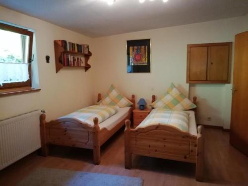 a bedroom with two beds and a window at Ferienhaus Burgblick in Bad Münstereifel