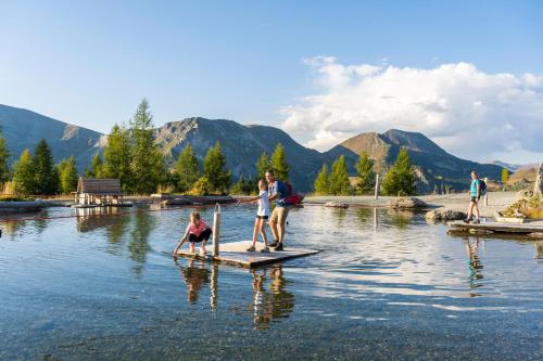 a group of people on a paddle board in the water at Residence Alba Montis in Bad Kleinkirchheim
