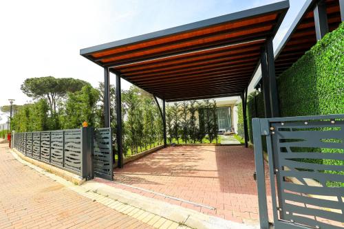 a pavilion with awning on a brick sidewalk at SanPietro Premium Villas in Draçi