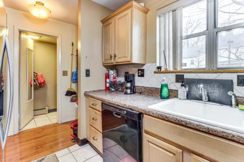 a kitchen with a sink and a dishwasher at 3 Mi to Dtwn New Haven Colorful Condo with Yard! in West Haven
