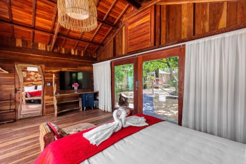 a bedroom with a bed with a red and white dress on it at Xainã Pousada de Charme in Cumbuco
