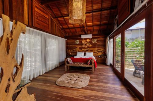 a bedroom in a house with a bed and a porch at Xainã Pousada de Charme in Cumbuco