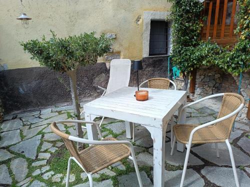a white table and chairs on a stone patio at La Borgata in Tovo San Giacomo