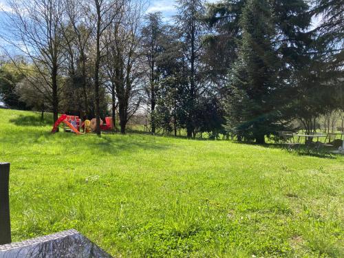 a park with a playground in a field of grass at Villa Vinea Prisca B&B in Cenate Sotto