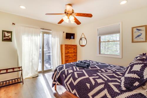 a bedroom with a bed and a ceiling fan at Walk to Lake Harmony Family Retreat with Decks! in Albrightsville