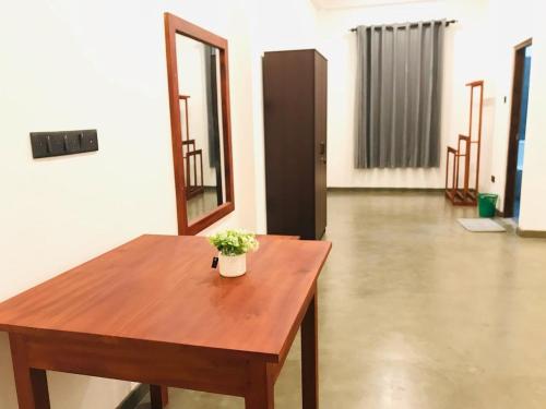 a wooden table with a potted plant on it in a room at Villa Alora in Kamburugamuwa