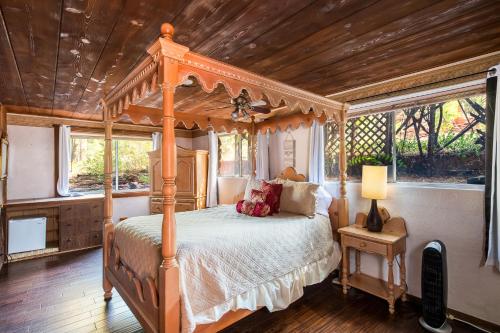 a bedroom with a canopy bed with a wooden ceiling at Saddle Rock Ranch B&B at West Sedona in Sedona