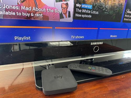 a remote control sitting next to a computer monitor at Sherfield Park Ensuite Room in Sherfield on Loddon