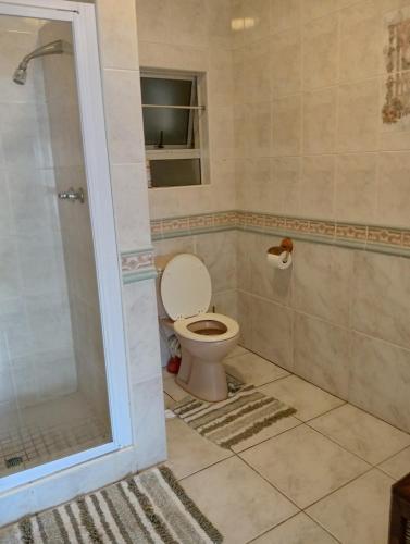 a bathroom with a toilet and a shower at Costa Smeralda Protea Block P2 in Margate